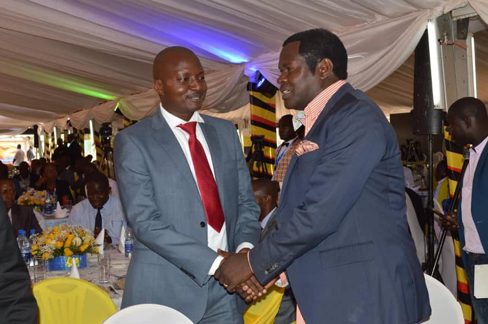 Pastor Bujingo in handshake withPastor Robert Kayanja